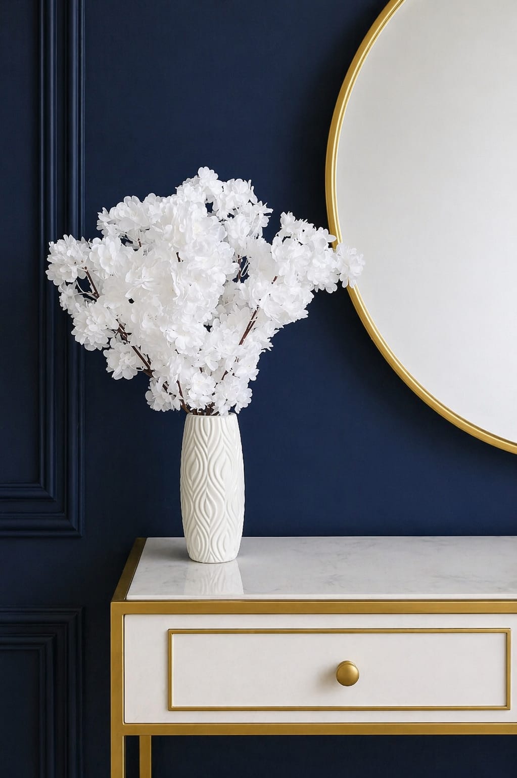 Elegant artificial flowers in a textured white plastic vase